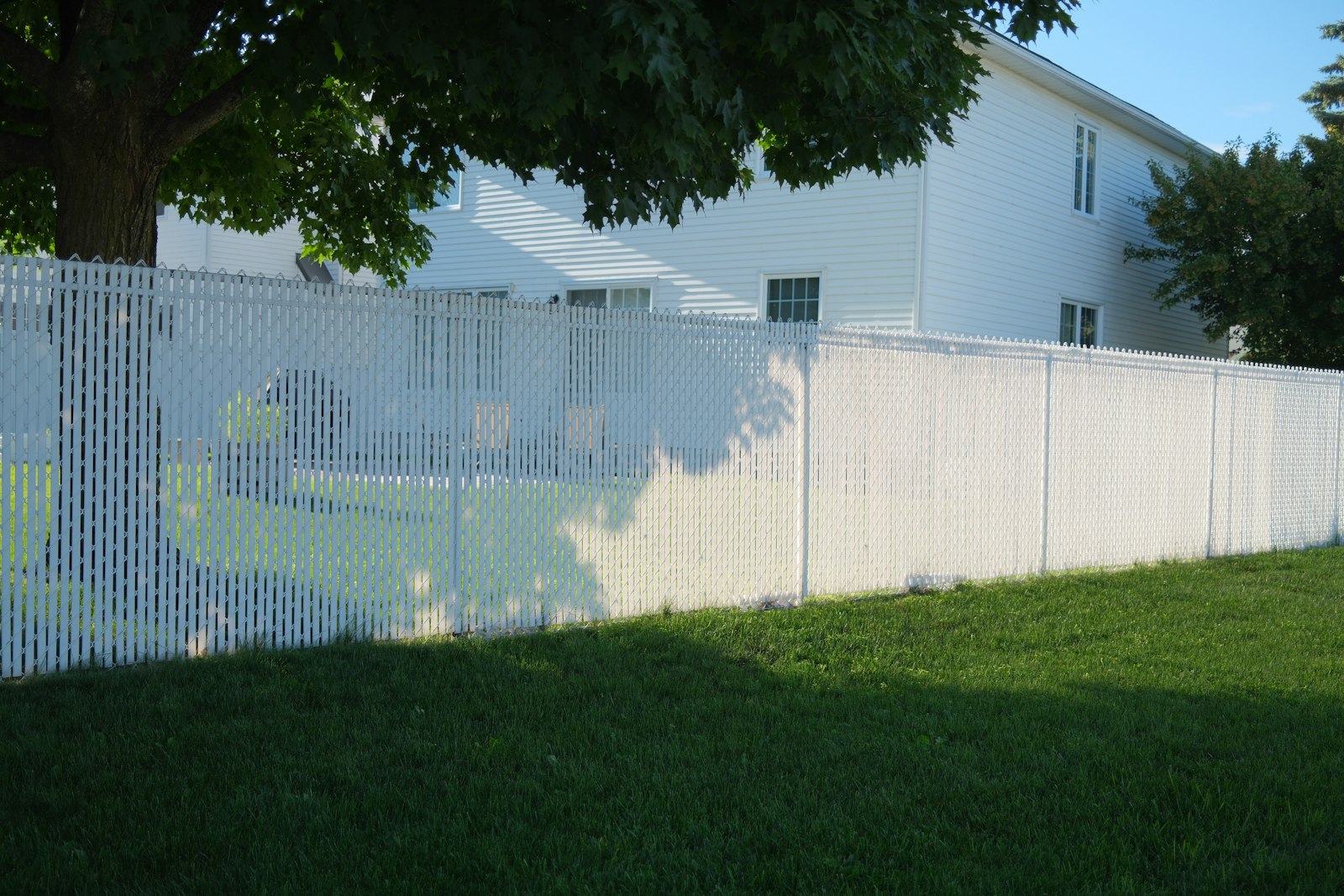 White fence in front of a house