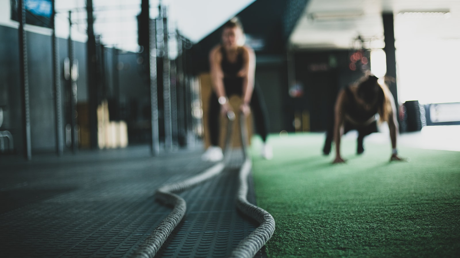 Personal trainer working with two clients in a gym